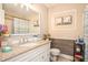 Elegant bathroom featuring a granite vanity top, framed mirror, and stylish decor at 999 Chestnut Oak Ct, Lawrenceville, GA 30046