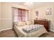 This bedroom features a ceiling fan, wood floors, and neutral tones at 999 Chestnut Oak Ct, Lawrenceville, GA 30046