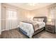 Comfortable bedroom with hardwood floors, soft lighting, and neutral tones at 999 Chestnut Oak Ct, Lawrenceville, GA 30046