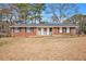 Charming single-story brick home featuring a welcoming front porch and well-maintained landscaping at 999 Chestnut Oak Ct, Lawrenceville, GA 30046