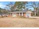 Cozy brick home with an attached garage and a well-kept lawn at 999 Chestnut Oak Ct, Lawrenceville, GA 30046