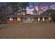 Charming single-story brick home featuring a welcoming front porch, photographed at dusk at 999 Chestnut Oak Ct, Lawrenceville, GA 30046