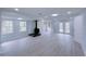 Finished basement featuring a wood-burning stove, recessed lighting, and light grey wood-look flooring at 341 Baggett Cir, Lawrenceville, GA 30044