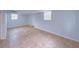 This basement room has tile flooring, two windows and white wall paneling at 341 Baggett Cir, Lawrenceville, GA 30044