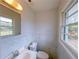 This half bath features a window and a modern white vanity at 341 Baggett Cir, Lawrenceville, GA 30044