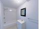 This bathroom offers a bathtub with shower and large mirror at 341 Baggett Cir, Lawrenceville, GA 30044