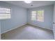 Bright bedroom featuring plush carpet flooring and large windows overlooking the backyard at 341 Baggett Cir, Lawrenceville, GA 30044