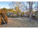 Expansive backyard featuring mature trees and a wooden staircase leading to the deck at 7025 Kimberly Mill Rd, Atlanta, GA 30349