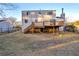 Backyard view featuring a large deck with stairs and a spacious yard at 7025 Kimberly Mill Rd, Atlanta, GA 30349