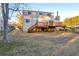 Large backyard with a spacious deck, stairs, and mature trees at 7025 Kimberly Mill Rd, Atlanta, GA 30349