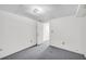 Carpeted room with white walls, open doorway, and simple ceiling lighting at 7025 Kimberly Mill Rd, Atlanta, GA 30349
