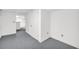Unfinished basement space with carpeting, white walls, and ample storage at 7025 Kimberly Mill Rd, Atlanta, GA 30349