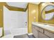 This well-lit bathroom features a shower-tub combo and a classic vanity at 7025 Kimberly Mill Rd, Atlanta, GA 30349