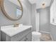 Bathroom featuring modern vanity, oval mirror, and tiled floors at 7025 Kimberly Mill Rd, Atlanta, GA 30349