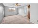 Bedroom with plush carpeting, ceiling fan, and window providing natural light at 7025 Kimberly Mill Rd, Atlanta, GA 30349