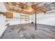 Spacious garage featuring concrete flooring, storage shelves, and a utility door at 7025 Kimberly Mill Rd, Atlanta, GA 30349