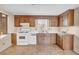 Cozy kitchen with wood cabinets, white countertops, and tile flooring at 7025 Kimberly Mill Rd, Atlanta, GA 30349
