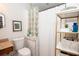 Well-lit bathroom featuring glass block wall and convenient shelving for storage at 981 Church St, Decatur, GA 30030