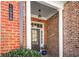 Close-up of a brick facade with white columns, showcasing the home's welcoming front entrance at 10416 Park Walk Pt, Alpharetta, GA 30022