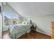 Bright bedroom featuring hardwood floors, sloped ceilings, and a window with neighborhood views at 2002 Wingate Rd, Atlanta, GA 30341