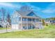 Charming two-story home with a spacious porch, and a two-car garage, set on a lush green lawn at 2002 Wingate Rd, Atlanta, GA 30341