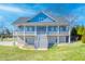 Stunning two-story home featuring a wide porch with a staircase and pillars, complemented by a verdant lawn at 2002 Wingate Rd, Atlanta, GA 30341