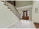 Inviting foyer featuring marble floors, a wooden front door and staircase at 2002 Wingate Rd, Atlanta, GA 30341