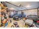 Large, cluttered garage with cars, shelving, and storage items at 2002 Wingate Rd, Atlanta, GA 30341