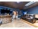 Spacious living room with tile floors, entertainment center, and leather reclining sofa at 2002 Wingate Rd, Atlanta, GA 30341