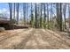 A large, flat backyard with grass, surrounded by mature trees and landscaping at 2626 Shadow Woods Ne Cir, Marietta, GA 30062