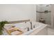 Bright white bathroom features a tub and large glass shower, next to built-in shelves at 2626 Shadow Woods Ne Cir, Marietta, GA 30062
