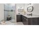 Modern bathroom featuring gray cabinets, a double sink, vanity mirrors and a glass enclosed shower at 2626 Shadow Woods Ne Cir, Marietta, GA 30062