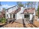 A view of the home's backyard and deck with modern patio furniture at 2626 Shadow Woods Ne Cir, Marietta, GA 30062