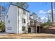 A view of the home's rear exterior showing deck, patio, and garage at 2626 Shadow Woods Ne Cir, Marietta, GA 30062