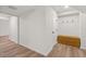 Well lit hallway featuring a built in bench, coat hooks, and wood look flooring at 2626 Shadow Woods Ne Cir, Marietta, GA 30062