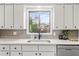 Kitchen featuring white cabinets, a modern faucet, and a stainless steel dishwasher at 2626 Shadow Woods Ne Cir, Marietta, GA 30062