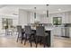Modern kitchen with white cabinets, an island with seating, and a dining area nearby at 2626 Shadow Woods Ne Cir, Marietta, GA 30062