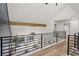 Second story loft with black metal railing and views of the living room at 2626 Shadow Woods Ne Cir, Marietta, GA 30062