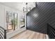 Bright open loft area with wood-style flooring, black accent wall and large windows at 2626 Shadow Woods Ne Cir, Marietta, GA 30062