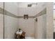 Modern walk-in shower with neutral stone tiling, glass doors and a shower niche at 2626 Shadow Woods Ne Cir, Marietta, GA 30062