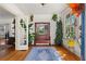 Bright foyer with hardwood floors, plants, and an antique mirror with bench seating at 2653 Brookwood Ne Dr, Atlanta, GA 30305