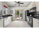 Modern kitchen with white cabinets, stainless steel appliances, and access to the outdoor deck at 2653 Brookwood Ne Dr, Atlanta, GA 30305