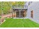 Spacious backyard with artificial turf, covered patio, tiered landscaping and upstairs deck at 3882 The Ascent Ne, Brookhaven, GA 30319