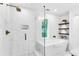 Sleek bathroom featuring white tile walls, glass shower and separate soaking tub next to natural light window at 3882 The Ascent Ne, Brookhaven, GA 30319