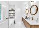 Modern bathroom with double sink vanity, wood drawers, and soaking tub under oversized window at 3882 The Ascent Ne, Brookhaven, GA 30319