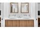 Elegant bathroom with a wooden vanity, dual vessel sinks, and modern fixtures at 3882 The Ascent Ne, Brookhaven, GA 30319