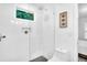 Sleek bathroom with glass enclosed shower, contemporary tiling, and floating vanity with decor niche at 3882 The Ascent Ne, Brookhaven, GA 30319