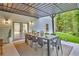 Covered patio with large dining table, ideal for outdoor entertaining next to lush greenery at 3882 The Ascent Ne, Brookhaven, GA 30319