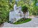 Beautiful two-story home nestled among mature trees, with lush landscaping, and a curved driveway at 3882 The Ascent Ne, Brookhaven, GA 30319