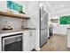 Modern kitchen with stainless steel appliances, wine fridge, sink with gold fixtures and countertop at 3882 The Ascent Ne, Brookhaven, GA 30319